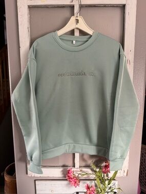 Mint/sage Green Crewneck Sweatshirt with Embroidered “Overstimulated” script.